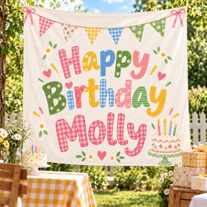 May include: A white fabric banner featuring the text Happy Birthday Molly in colorful, patterned letters. The design includes a bunting flag garland at the top with pink bows, small hearts, and daisy flowers. A birthday cake illustration is on the bottom right.