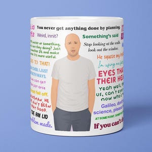May include: White ceramic mug with a bald man in a white t-shirt and grey trousers. The mug is decorated with colourful text quotes. The mug is set against a blue backdrop.