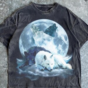 May include: Dark gray t-shirt featuring a graphic of wolves howling at a full moon. The design includes a white, black, and gray wolf, with the text "Mad Kitten" in the upper right corner and "Pepper" at the bottom.