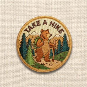 May include: Embroidered patch featuring a brown bear with a backpack and walking stick, hiking through a forest. The patch has the text "TAKE A HIKE" in a circular design, with mountains and trees in the background. The patch is round and has a tan border.
