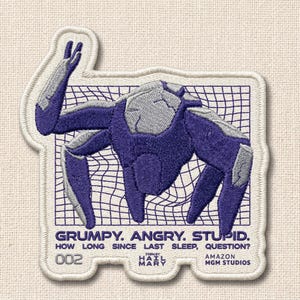 May include: Embroidered patch featuring a purple and gray robotic figure within a white grid. Text includes "GRUMPY. ANGRY. STUPID." and "HOW LONG SINCE LAST SLEEP, QUESTION?" with "002" and studio information. The patch has a white border.