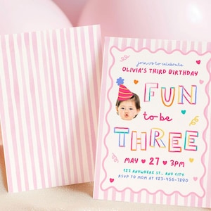 May include: A rectangular birthday invitation card with a pink and white vertical striped border. The text reads: join us to celebrate OLIVIA'S THIRD BIRTHDAY FUN to be THREE MAY 27 3PM 123 ANYWHERE ST., ANY CITY RSVP TO MOM AT 123-456-7890.