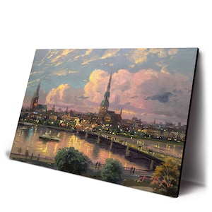 May include: A white ceramic mug with a black handle and the text "But First, Coffee" in a black, bold font. The mug is on a white surface.