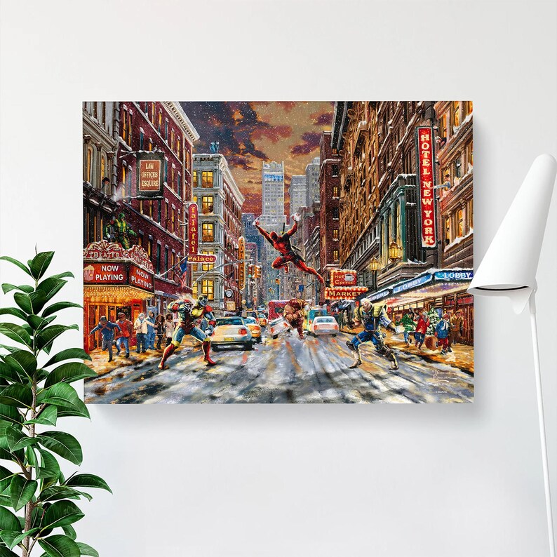 May include: A canvas print depicting a cityscape with superheroes in action. The artwork features a vibrant street scene with buildings, cars, and figures in superhero costumes. The words "Now Playing" are visible on a theater marquee.