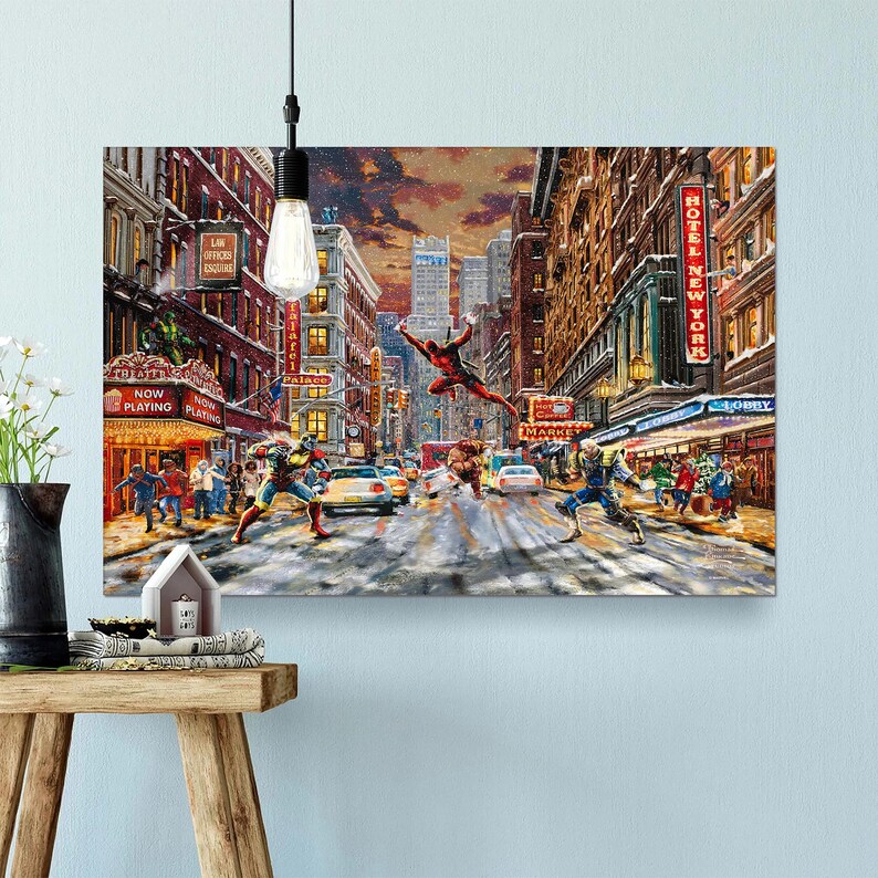 May include: A canvas print depicting a comic book scene in a snowy New York City street. Superhero figures are in action, with a red-suited character leaping. Buildings and theater marquees are visible.