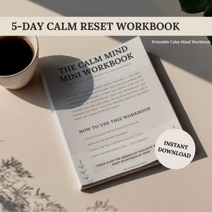 May include: A workbook titled "The Calm Mind Mini Workbook" with the text "5-Day Calm Reset Workbook" at the top. A cup of coffee sits to the left. The workbook includes instructions and the words "Instant Download" on a sticker.