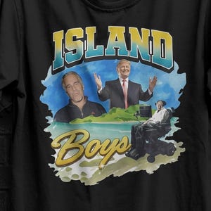 May include: Black t-shirt featuring the text "ISLAND Boys" in a stylized font, with images of three men. The shirt also has a yellow and black graphic of a plane and the text "SEVENTHREESEVEN".
