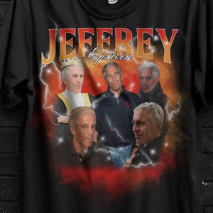 May include: Black t-shirt featuring a graphic of several men with the name "JEFFREY Epstein" in a retro font. The shirt has a vintage design with lightning bolts and a red and orange gradient.