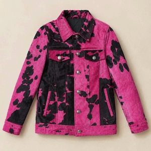 May include: A long-sleeved jacket featuring a vibrant hot pink and black cow print pattern. The garment includes a classic collar, a front button-down closure with metallic buttons, two chest pockets with buttoned flaps, and two vertical side pockets.