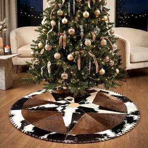 May include: A circular Christmas tree skirt featuring a geometric star pattern constructed from panels of brown and black-and-white cowhide. The design includes a central circular patch and a stitched border edge, placed beneath a decorated tree.