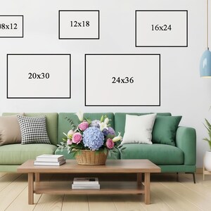 May include: Five framed art prints in various sizes (20x30 cm, 30x46 cm, 41x61 cm, 51x76 cm, and 61x91 cm) are displayed on a white wall above a green sofa. A coffee table holds books and a flower arrangement.