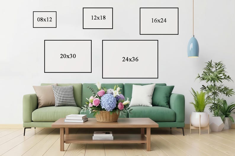 May include: Five framed art prints in various sizes (20x30 cm, 30x46 cm, 41x61 cm, 51x76 cm, and 61x91 cm) are displayed on a white wall above a green sofa. A coffee table holds books and a flower arrangement.