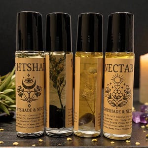 May include: Four glass roller bottles with black lids and tan labels. The labels read "NIGHTSHADE & NECTAR" and "NECTAR" with botanical and celestial designs. The bottles contain clear and yellow liquids with plant matter.