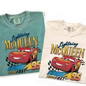 May include: A set of three ceramic mugs with a speckled, matte finish. Each mug features a different color: light blue, cream, and gray. The mugs have a simple, modern design with a rounded shape and a handle.