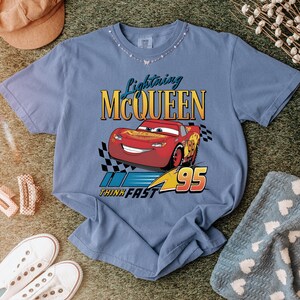 May include: A set of three ceramic mugs with a speckled, matte finish. The mugs are in shades of cream, light gray, and dark gray. Each mug has a simple, modern design and a rounded handle.