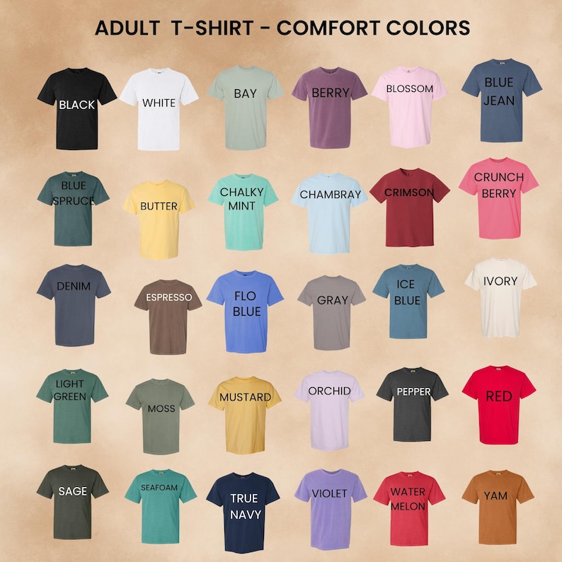May include: A grid of thirty short-sleeved crew neck t-shirts in various colours, labelled with text including Black, White, Bay, Berry, Blossom, Blue Jean, Blue Spruce, Butter, Chalky Mint, Chambray, Crimson, Crunch Berry, Denim, Espresso, Flo Blue, Gray, Ice Blue, Ivory, Light Green, Moss, Mustard, Orchid, Pepper, Red, Sage, Seafoam, True Navy, Violet, Watermelon, and Yam. The header reads ADULT T-SHIRT - COMFORT COLORS.