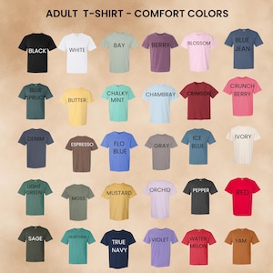 May include: A color chart for adult Comfort Colors t-shirts featuring thirty short-sleeve shirts in various shades including black, white, bay, berry, blossom, blue jean, blue spruce, butter, chalky mint, chambray, crimson, crunch berry, denim, espresso, flo blue, gray, ice blue, ivory, light green, moss, mustard, orchid, pepper, red, sage, seafoam, true navy, violet, watermelon, and yam.