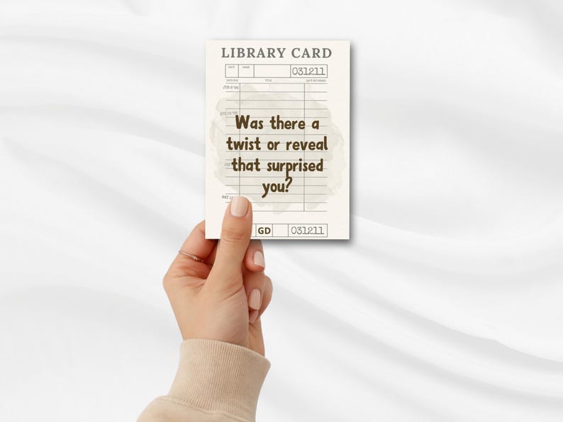 May include: A library card with the text "Was there a twist or reveal that surprised you?" in a vintage style. The card has a cream background with brown text and lines. The card is held by a hand.