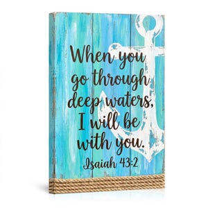 May include: Wooden wall art with a distressed blue and white painted background. A white anchor is on the right side. The text reads "When you go through deep waters, I will be with you. Isaiah 43:2."