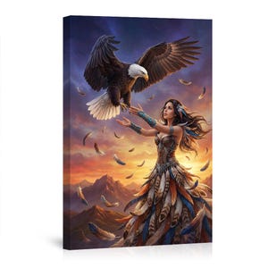 May include: A canvas print depicts a woman in a feathered dress with an eagle. The eagle, with its wings spread, hovers above her outstretched hands. Feathers float in the air against a sunset backdrop with mountains.