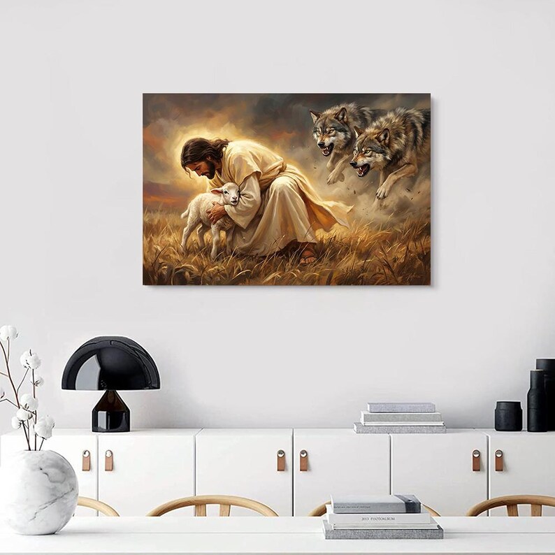 May include: A canvas print depicting a religious scene. A figure in a cream-colored robe cradles a lamb in a field of tall grass. Two wolves are in the background, with a cloudy sky above.
