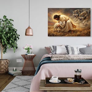 May include: A framed canvas art print depicts a religious scene. A figure in a white robe embraces a lamb in a field of wheat, with two wolves in the background. The artwork is displayed above a bed with pink bedding.
