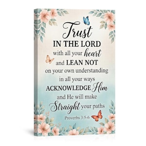 May include: A canvas wall art print featuring the text "Trust in the Lord" with a floral and butterfly design. The artwork includes a light blue background and decorative flowers in shades of pink and peach.