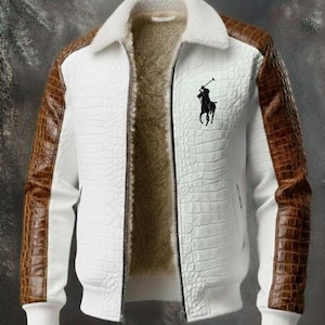May include: White jacket with brown faux-leather sleeves and a white faux-fur collar. The jacket features a textured pattern and a black logo on the chest. The interior is lined with a soft, brown material. A stylish outerwear piece.
