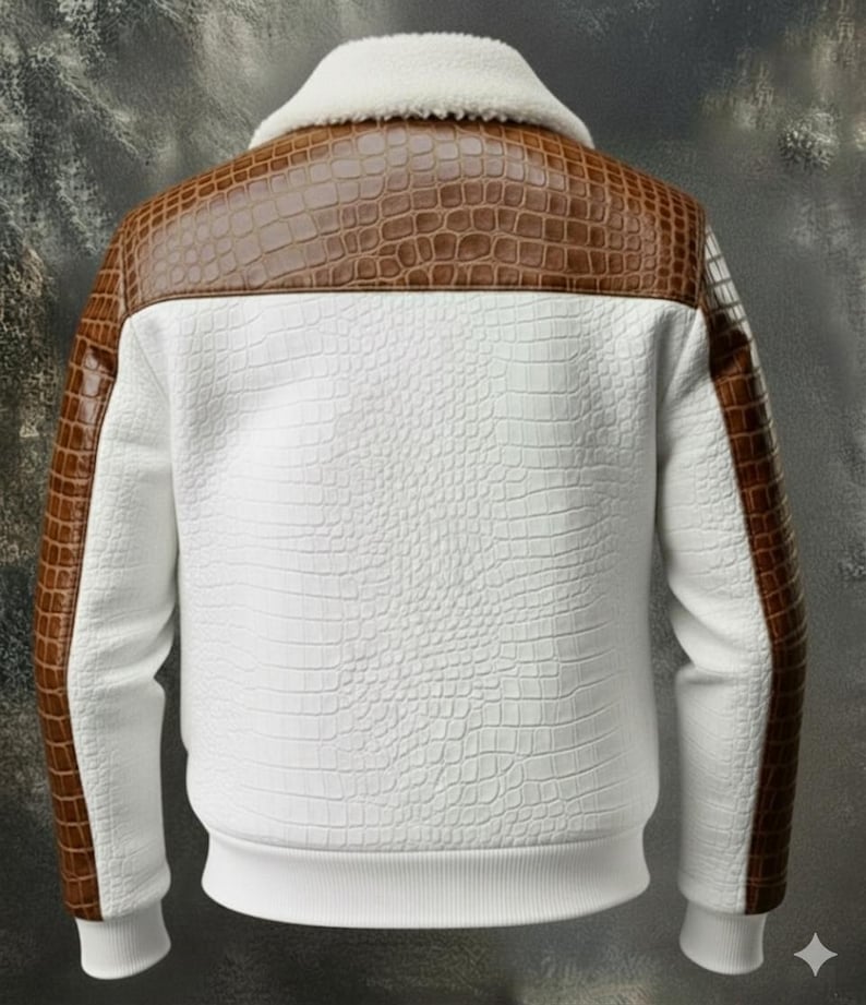 May include: A white jacket with brown faux crocodile leather accents on the shoulders and sleeves. The jacket has a white, textured pattern and a white, fluffy collar. The cuffs and hem are ribbed.