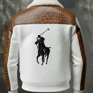 May include: White jacket with brown faux-crocodile accents on the shoulders and sleeves. Features a white faux-crocodile textured back panel with a black polo player logo. The collar is white and fluffy.