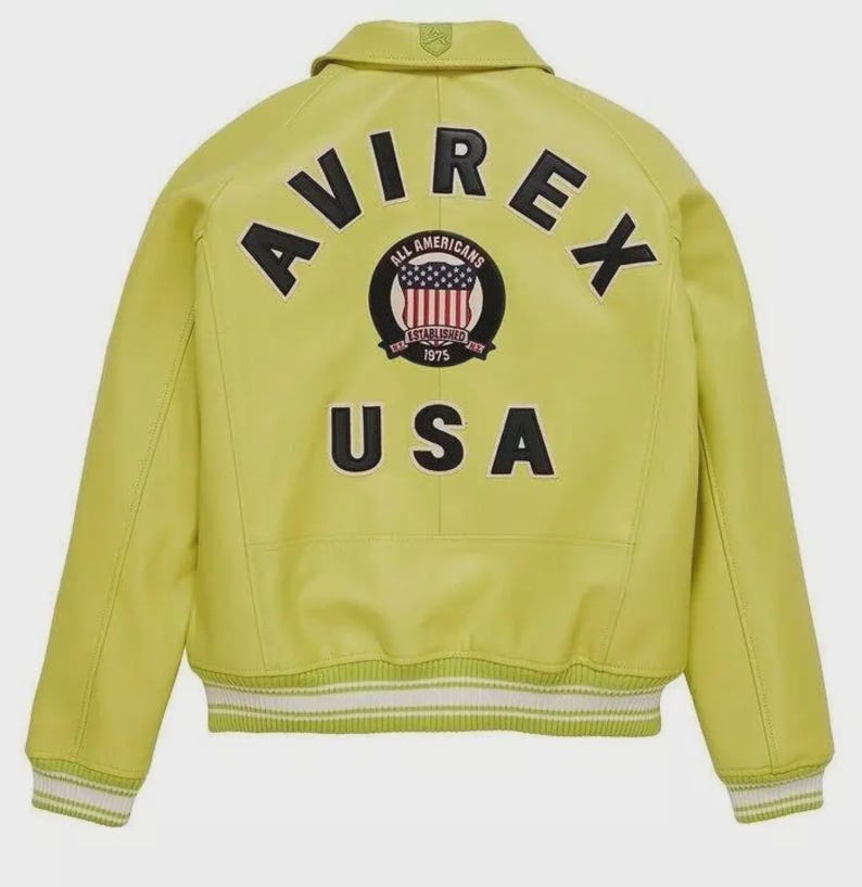 May include: A chartreuse leather jacket with the word "AVIREX" arched across the back in black block letters. Below the word "AVIREX" is a circular patch with the words "ALL AMERICANS ESTABLISHED 1975" and a graphic of the American flag. The word "USA" is below the patch.