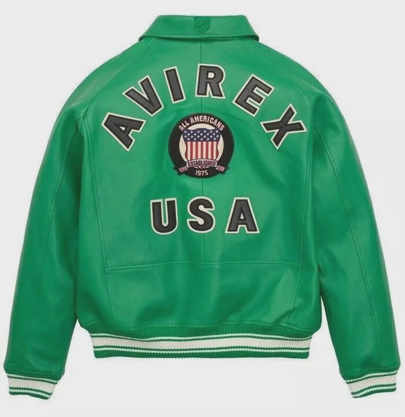 May include: A green leather jacket with the word "AVIREX" arched across the shoulders. Below the word is a circular patch with the words "ALL AMERICANS ESTABLISHED 1975" and a US flag design. The word "USA" is below the patch. The jacket has a white and black striped hem.