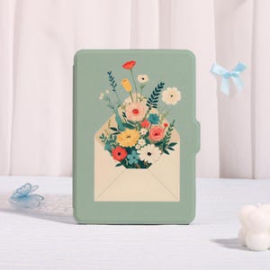 May include: A mint green tablet case with a floral design. The design depicts a bouquet of colourful flowers emerging from an open envelope. The flowers include red, yellow, pink, and white blooms with green foliage.