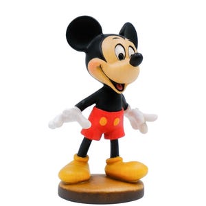 May include: A figurine of Mickey Mouse, a classic cartoon character. Mickey is depicted with black ears, a black body, red shorts, yellow shoes, and white gloves. The figurine is standing on a brown base.
