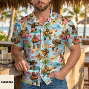 May include: Light blue button-down shirt with a tropical print featuring cartoon gorillas enjoying beach activities. The design includes waves, pineapples, beach balls, and flowers. The shirt has short sleeves and a classic collar.