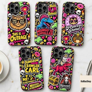 May include: Five black smartphone cases featuring colorful sticker-style graphics including cats, dinosaurs, skulls, donuts, and text such as This Is An Outrage, Mongo Is Appalled, Princess Donut, Dungeon Crawler Carl, New Achievement, and Prepotente.