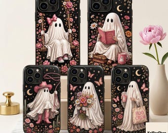 May include: Five black phone cases featuring white ghost illustrations. One ghost sits on a swing, one reads a book, one wears a cowboy hat and boots, one holds a bouquet of flowers, and one carries a tote bag labeled BOO CREW. All designs include pink flowers, stars, and crescent moons.