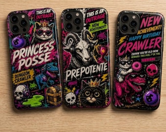 May include: Three black smartphone cases featuring vibrant, multi-colored graphic prints. The designs include cats wearing crowns and sunglasses, a dinosaur, skulls, treasure chests, and text such as "Princess Posse," "Prepotente," and "New Achievement."