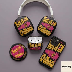 May include: A collection of black accessories with the phrase "THIS IS AN OUTRAGE" in yellow and pink. Includes headphones, a phone case, an Airpods case, and a button. The headphones have a white headband.