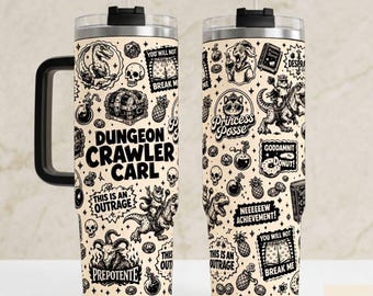 May include: Two stainless steel tumblers with handles and straws, featuring a cream background and black line art illustrations of skulls, treasure chests, dinosaurs, and text including Dungeon Crawler Carl, Princess Posse, and This Is An Outrage.