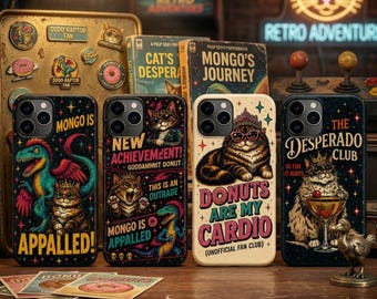May include: Four smartphone cases featuring colorful graphic illustrations of cats and dinosaurs. The designs include text such as MONGO IS APPALLED, NEW ACHIEVEMENT, DONUTS ARE MY CARDIO, and THE DESPERADO CLUB, set against dark and light backgrounds.