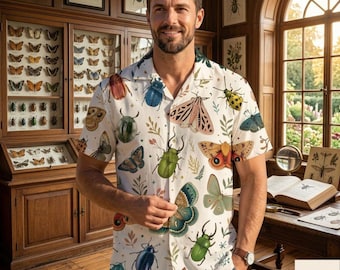 May include: A short-sleeved button-down shirt featuring an all-over print of various colorful beetles, moths, and butterflies interspersed with small botanical sprigs on a white background, worn with blue denim pants.