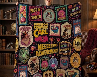 May include: A black fleece blanket featuring a colorful collage of Dungeon Crawler Carl graphics, including text like 'Best in Dungeon', 'New Achievement', and 'Princess Donut', alongside illustrations of cats, a dinosaur, and potions.
