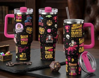 May include: Three black stainless steel tumblers with pink handles and lids, featuring colorful graphics of dinosaurs, cats, skulls, and treasure chests. Text includes "This is an outrage," "Dungeon Crawler Carl," and "New Achievement Happy Birthday Crawler."