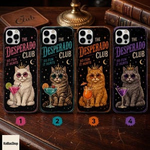 May include: Four black phone cases featuring a cat wearing a crown and sunglasses with a cocktail. Each case displays the text THE DESPERADO CLUB SO FUN IT HURTS. The cats are white, tabby, orange, and gray, with matching colored drinks.