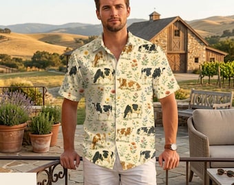 May include: A short-sleeve button-down shirt featuring an all-over print of black and white cows, brown and white cows, and colorful wildflowers on a cream background. The shirt has a classic collar and a straight hemline.