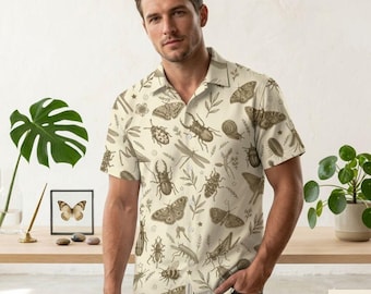 May include: A short-sleeve button-down shirt in a light cream color featuring an all-over print of various brown insects, beetles, and moths interspersed with small botanical leaf illustrations and a classic collar design.