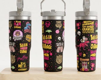 May include: Three black stainless steel tumblers with gray lids and handles, featuring a colorful graphic pattern of cats, dinosaurs, skulls, trophies, and text including "This is an outrage," "Princess Posse," and "Neeeeew Achievement."