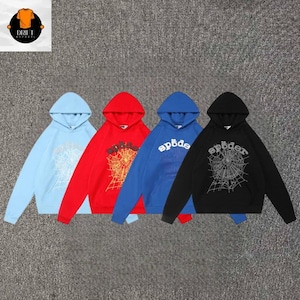 May include: Four hooded sweatshirts in light blue, red, blue, and black. Each hoodie features a white or yellow spiderweb graphic on the chest with the text "sp&ouml;der" printed above the web. The garments have long sleeves and a front kangaroo pocket.