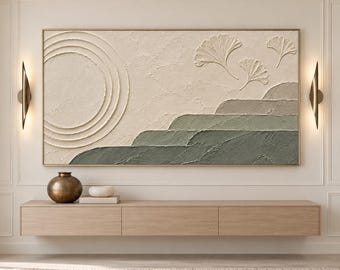 May include: A rectangular textured wall art piece featuring a large embossed circle on the left, three ginkgo leaf shapes in the upper right, and layered landscape hills in shades of cream, sage green, and dark olive green with a thick impasto finish.